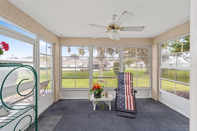 sunroom / solarium with ceiling fan and a healthy amount of sunlight