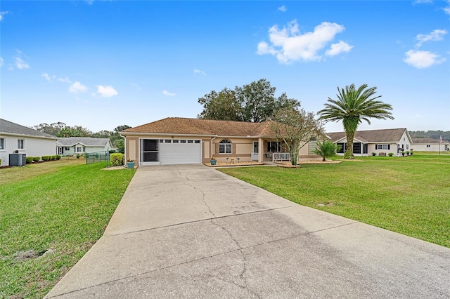 ranch-style house featuring central AC unit, a garage, and a front yard