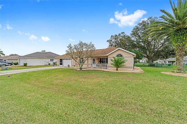 ranch-style house with covered porch, a garage, and a front lawn