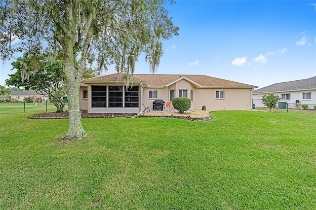 rear view of house with a lawn