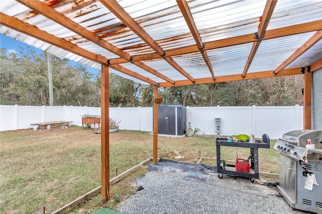 view of patio featuring grilling area and a storage unit