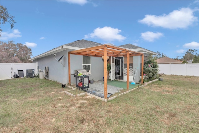 rear view of house with a yard, a pergola, central AC unit, and a patio area