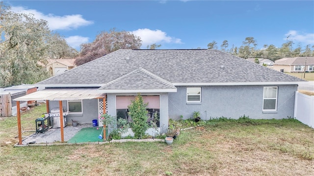 rear view of house with a yard and a patio