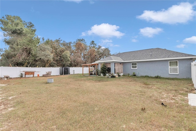 rear view of house featuring a lawn