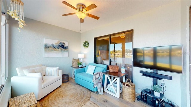 living room featuring ceiling fan and hardwood / wood-style flooring