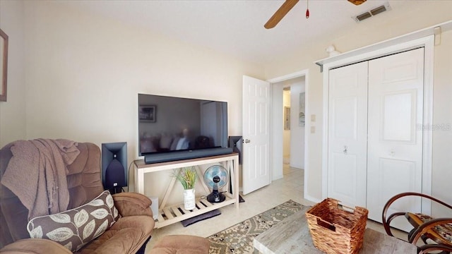 tiled living room featuring ceiling fan