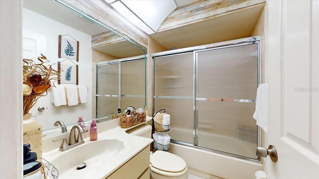 full bathroom with vanity, toilet, lofted ceiling, and enclosed tub / shower combo