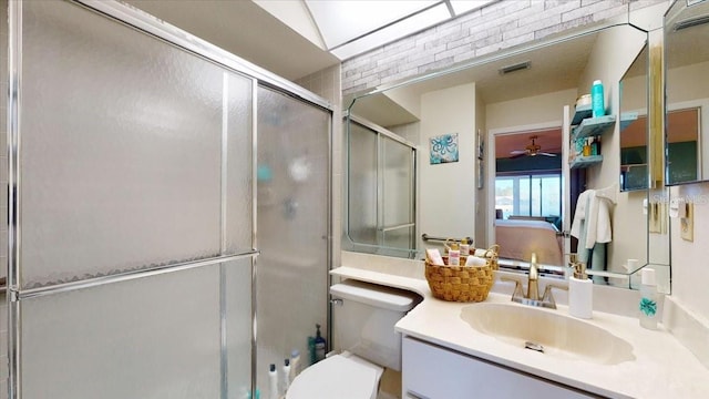 bathroom featuring vanity, ceiling fan, toilet, and walk in shower