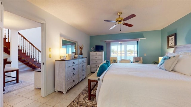 tiled bedroom featuring ceiling fan