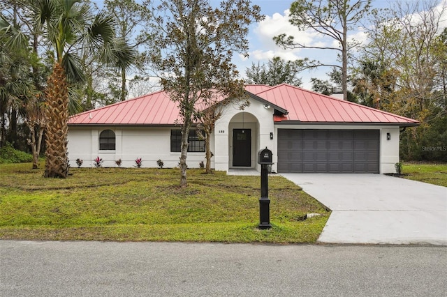 view of front of house featuring a garage and a front yard