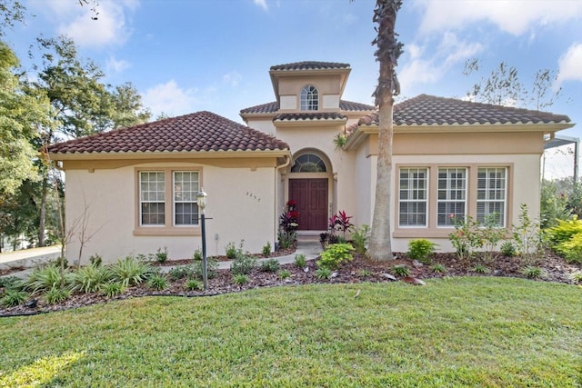 mediterranean / spanish home with a front yard