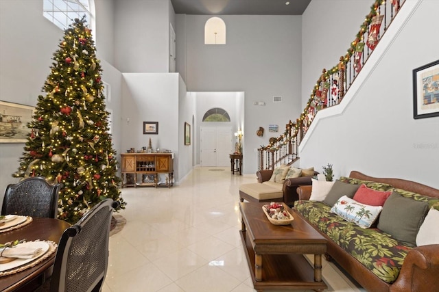 tiled living room with a high ceiling