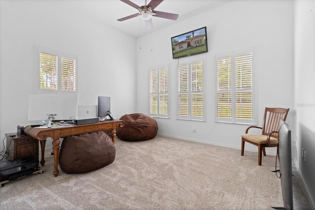 sitting room featuring light carpet and ceiling fan