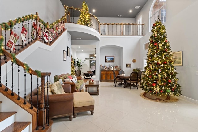 entryway with a high ceiling and light tile patterned flooring