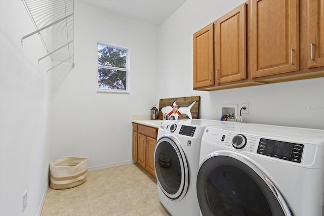 laundry area featuring cabinets and independent washer and dryer