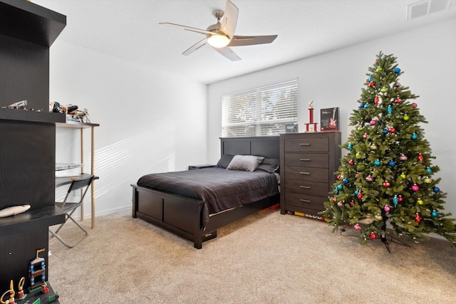 bedroom with ceiling fan and light colored carpet