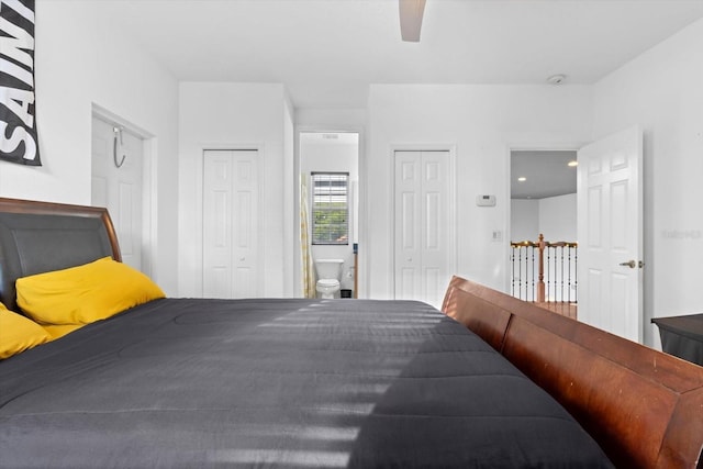 bedroom with ceiling fan, multiple closets, and ensuite bath