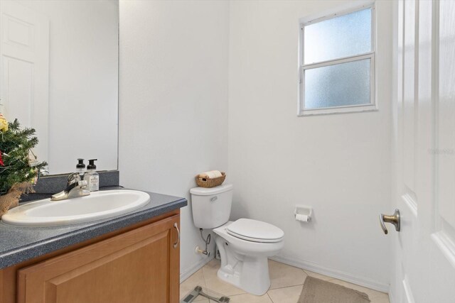 bathroom with tile patterned flooring, vanity, and toilet