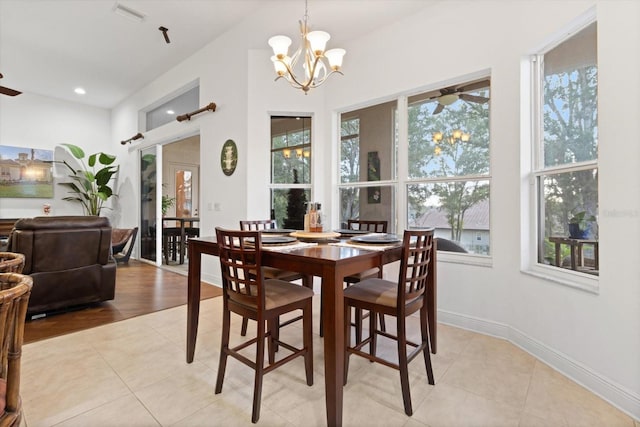 tiled dining area featuring a chandelier