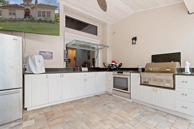 kitchen with ceiling fan, white cabinetry, white appliances, and vaulted ceiling