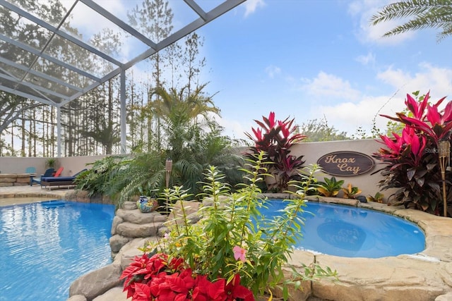 view of pool with a lanai