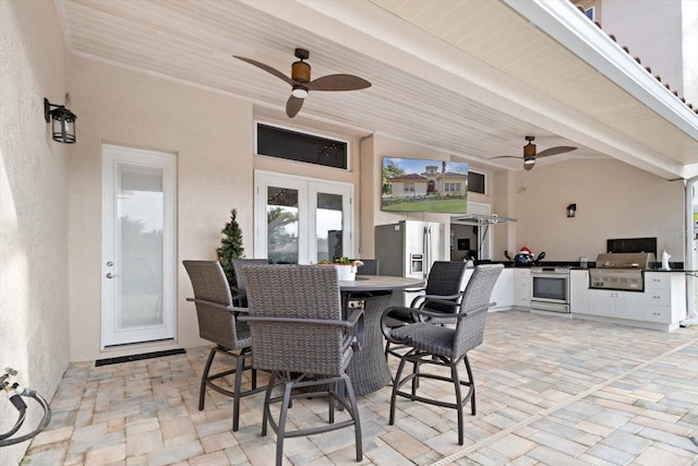 view of patio featuring french doors, area for grilling, and ceiling fan