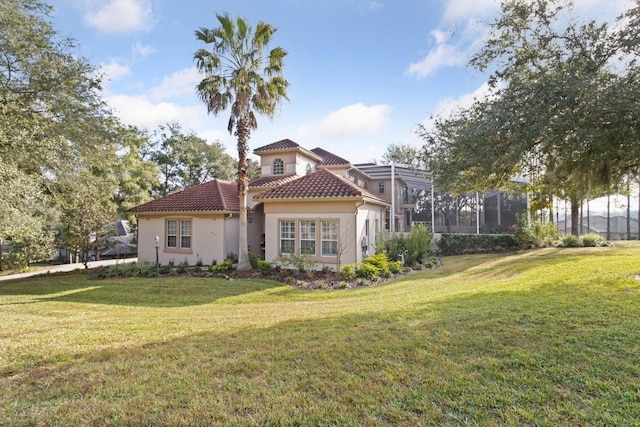 rear view of property featuring a yard