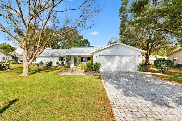 ranch-style home with a front lawn and a garage