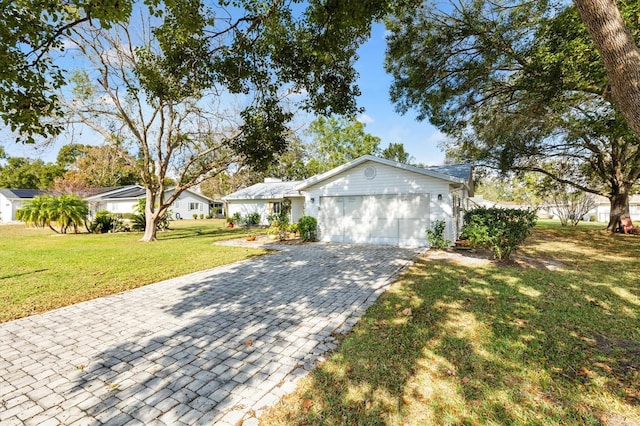 single story home featuring a garage and a front lawn