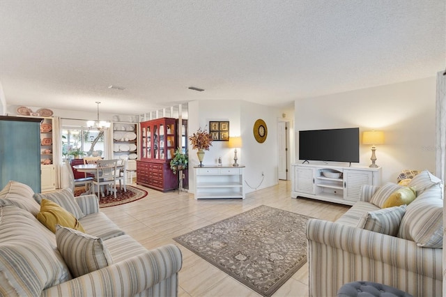 living room with a textured ceiling and a chandelier