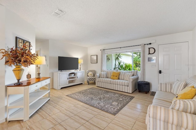 tiled living room with a textured ceiling