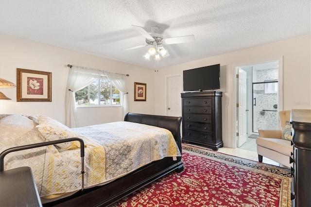 bedroom with ensuite bathroom, ceiling fan, and a textured ceiling