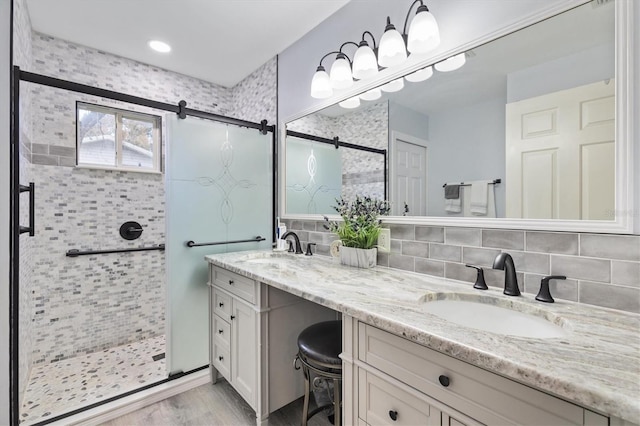 bathroom featuring vanity, tasteful backsplash, and walk in shower