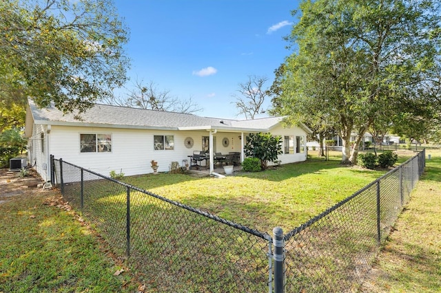 rear view of property featuring a lawn, a patio, and central AC unit