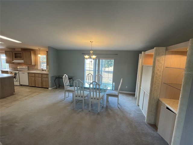 unfurnished dining area featuring light colored carpet, sink, and an inviting chandelier