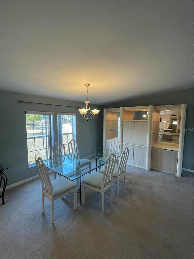 carpeted dining area featuring a notable chandelier