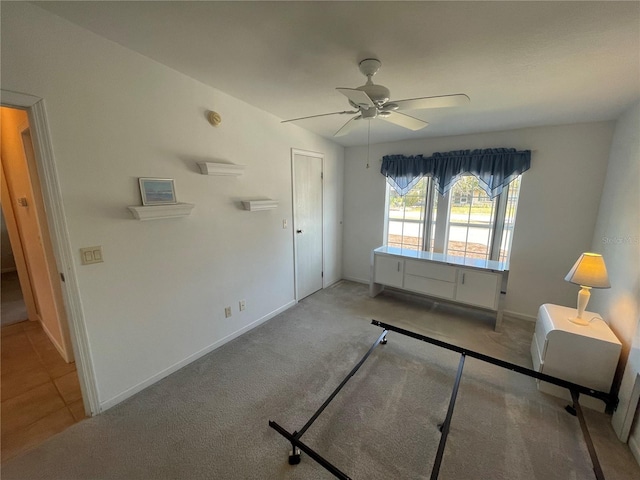 unfurnished bedroom with light carpet, a closet, and ceiling fan