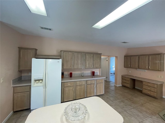 kitchen with light tile patterned floors and white fridge with ice dispenser