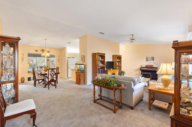 living room featuring light colored carpet and ceiling fan with notable chandelier