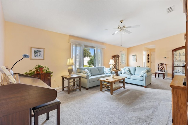 carpeted living room with ceiling fan