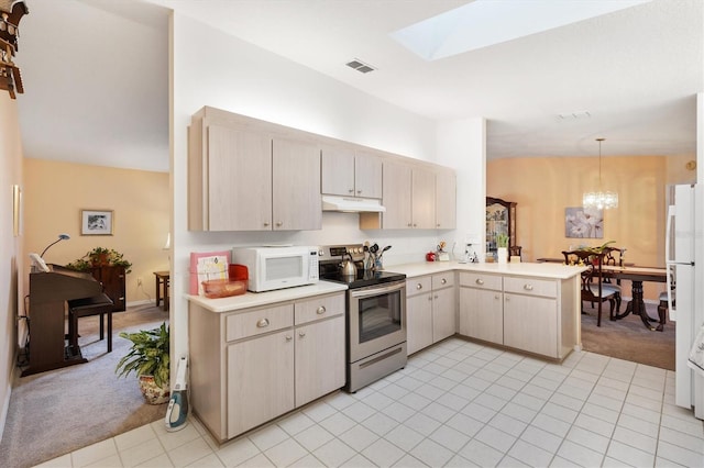 kitchen featuring kitchen peninsula, light carpet, white appliances, pendant lighting, and a notable chandelier