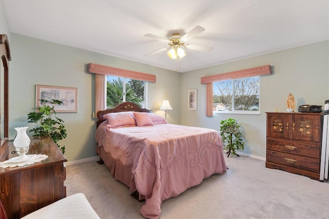 bedroom featuring ceiling fan and light colored carpet