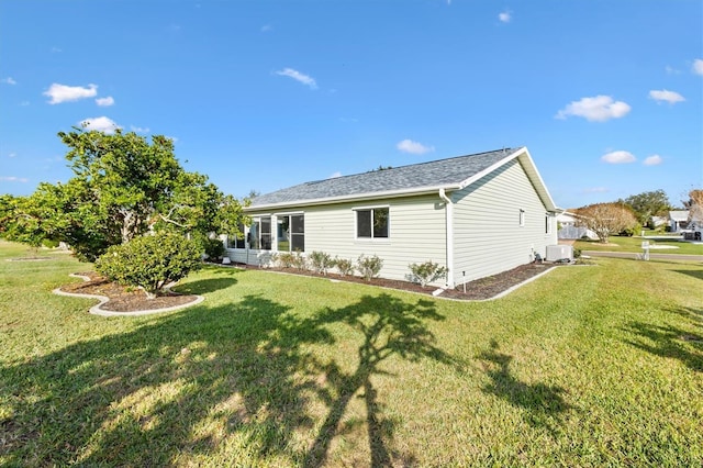 back of property featuring a yard and central AC unit