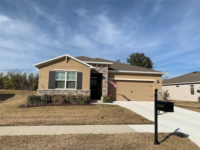 view of front of home with a garage and a front yard