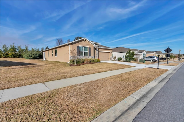 view of front of property with a garage and a front lawn