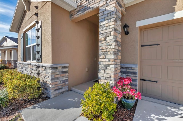 view of exterior entry featuring a garage