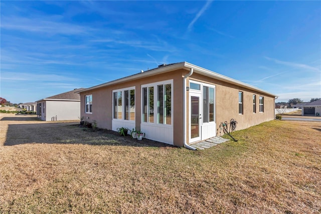 rear view of house featuring a yard