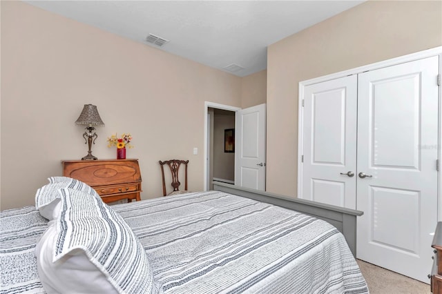 bedroom with light colored carpet and a closet