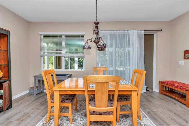 dining room with an inviting chandelier and light wood-type flooring