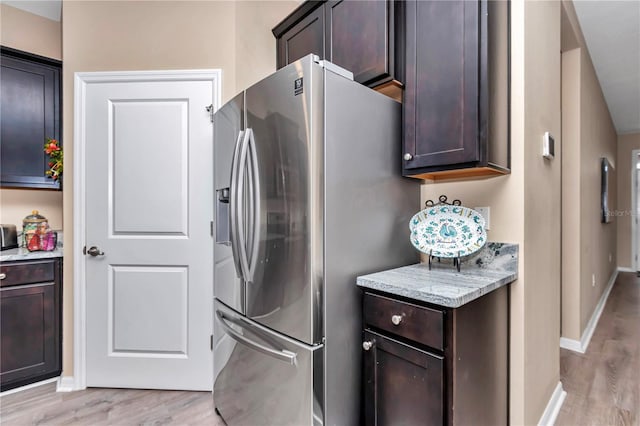 laundry area with cabinets and light hardwood / wood-style floors